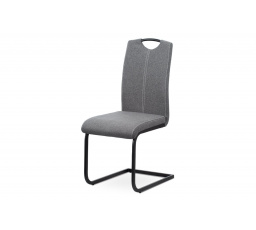 Jedálenská stolička, sivé látkové čalúnenie, biele prešitie, kovová podnož, čierny matný lak